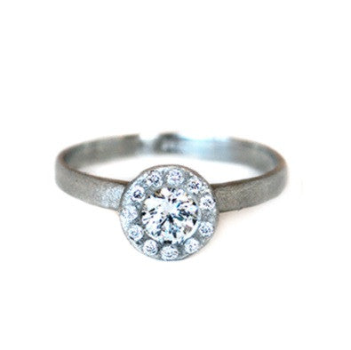14kt white gold ring with a round brilliant diamond with a halo of diamonds and a textured finish