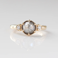 14k Yellow Gold Band featuring a natural rose cut salt & pepper diamond held securely in the middle with six prongs and accented by round brilliant cut diamonds