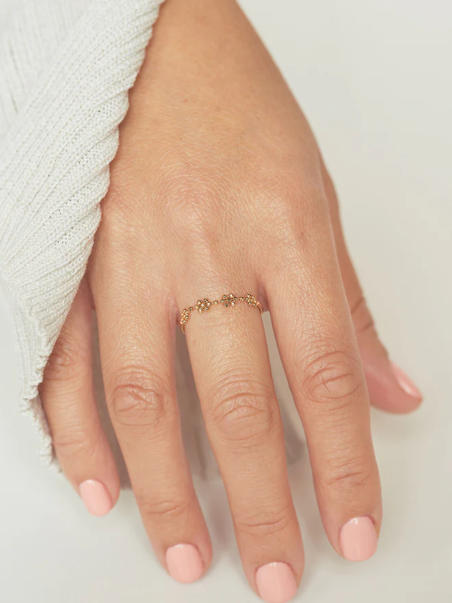 18k yellow gold ring featuring a beaded top shaped to be 4 mini flowers conected to a standard ring | on model