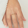 18k yellow gold ring featuring a beaded top shaped to be 4 mini flowers conected to a standard ring | on model