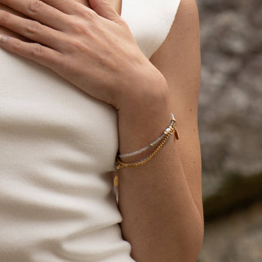 A moody gemstone ombré necklace featuring Moonstone, Labradorite &amp; Iolite with Freshwater Pearl and recycled brass accents. | on model