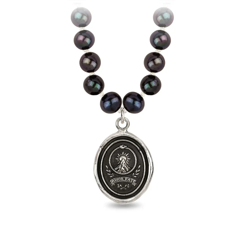 Peacock Black Freshwater Pearl Necklace with a Sterling Silver talisman depicting a Large mountain with a sun behind the peak, and the text "amor Fati" below it