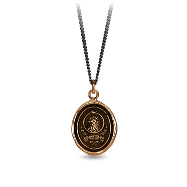 A Bronze Pyrrha talisman With a Talisman depicting a tall mountain with a sun rising over it, including the text "Amor fati" written beneath it