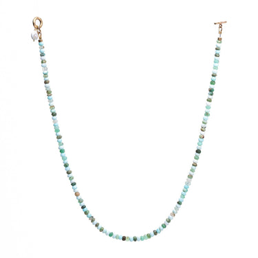 This Aqua necklace features Blue Peruvian Opal and Shiva Shell with a brass toggle clasp for convenient wear. 