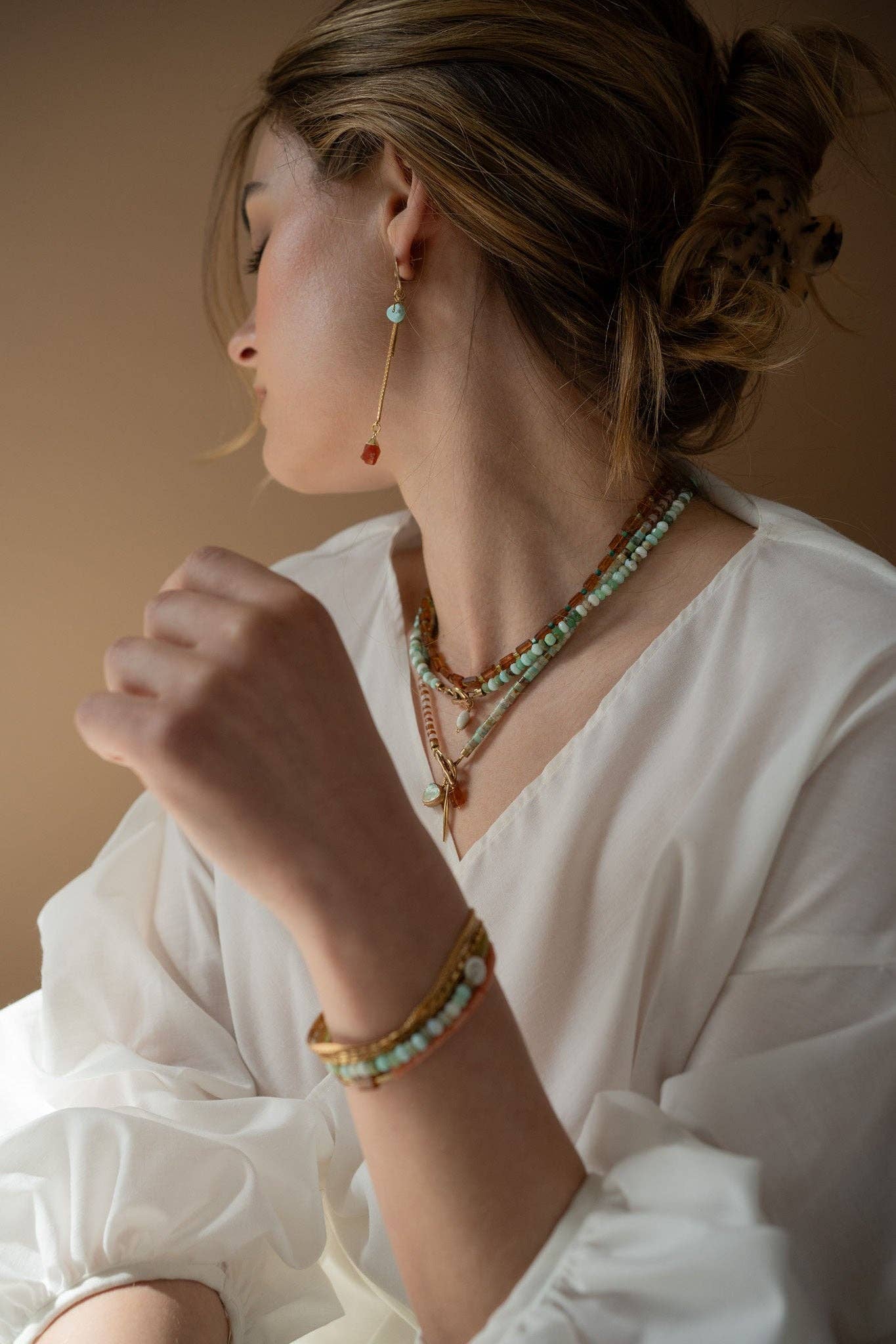 This Aqua necklace features Blue Peruvian Opal and Shiva Shell with a brass toggle clasp for convenient wear.  | on model