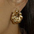 14k yellow Gold-plated brass Earring shaped like a crossiant with gold-plated sterling silver post and backings  | on model
