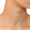 14k Yellow Gold Necklace with a Gold Star and a Turquoise Gemstone Embedded | On Model
