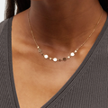 14k gold bead chain adorned with intricately crafted gold confetti elements in the center | on model
