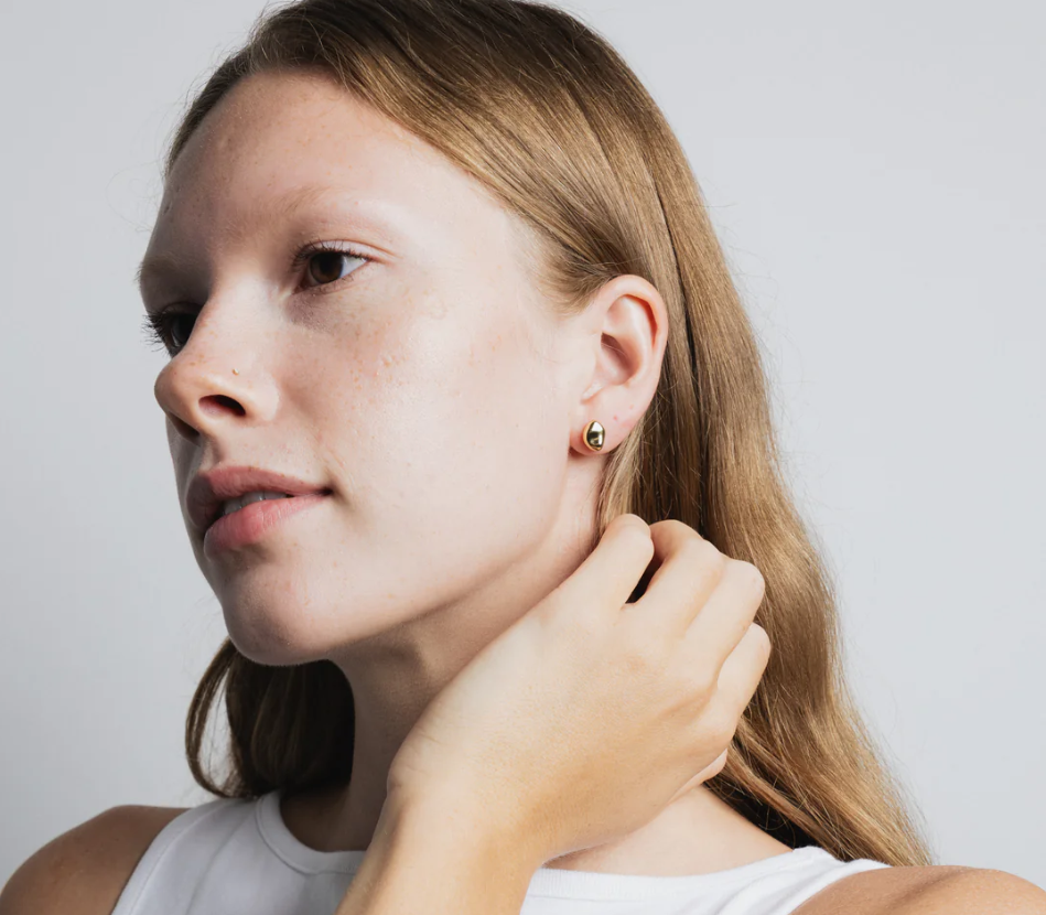 Small every day bean shaped stud earring made from 14k gold plated Brass | on model