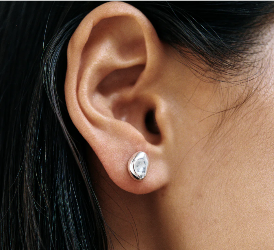 Small every day bean shaped stud earring made from sterling silver | on model