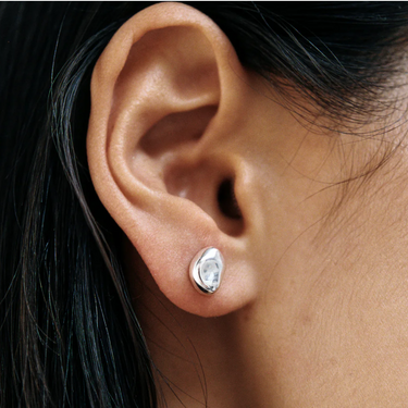 Small every day bean shaped stud earring made from sterling silver | on model