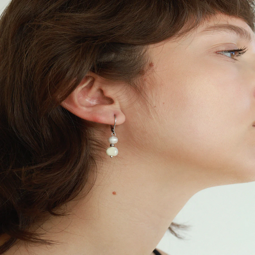 Delicate silver earrings with a freshwater pearl and a colorful bead | on model