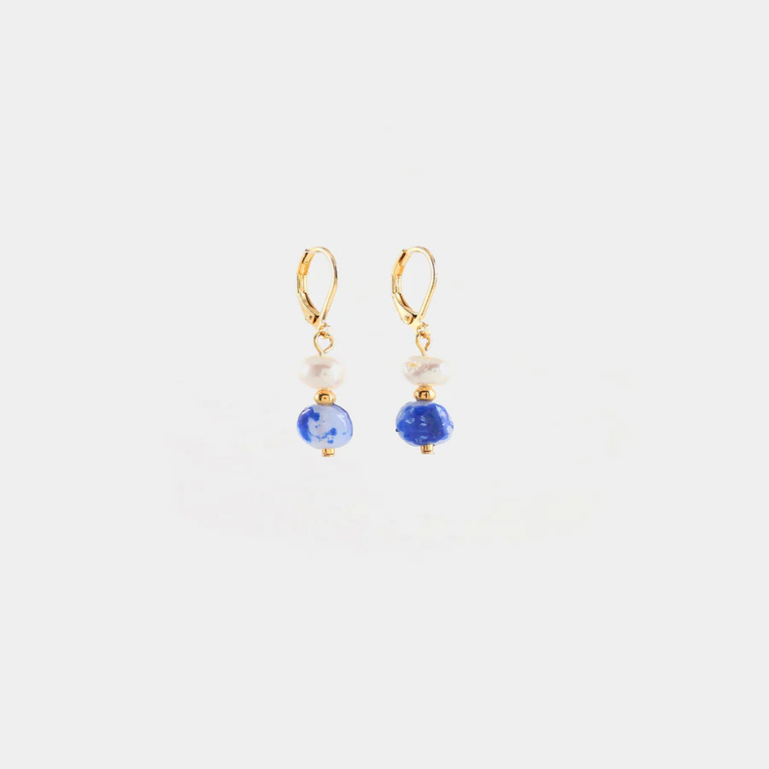Delicate gold earrings with a freshwater pearl and a colorful Blue bead