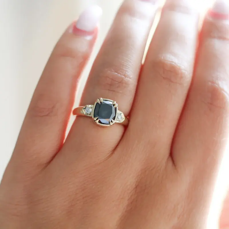 14k Yellow Gold Bezet Claw Set Ring featuring a 2.71ct cushion cut black diamond, with dia Accents | on hand model