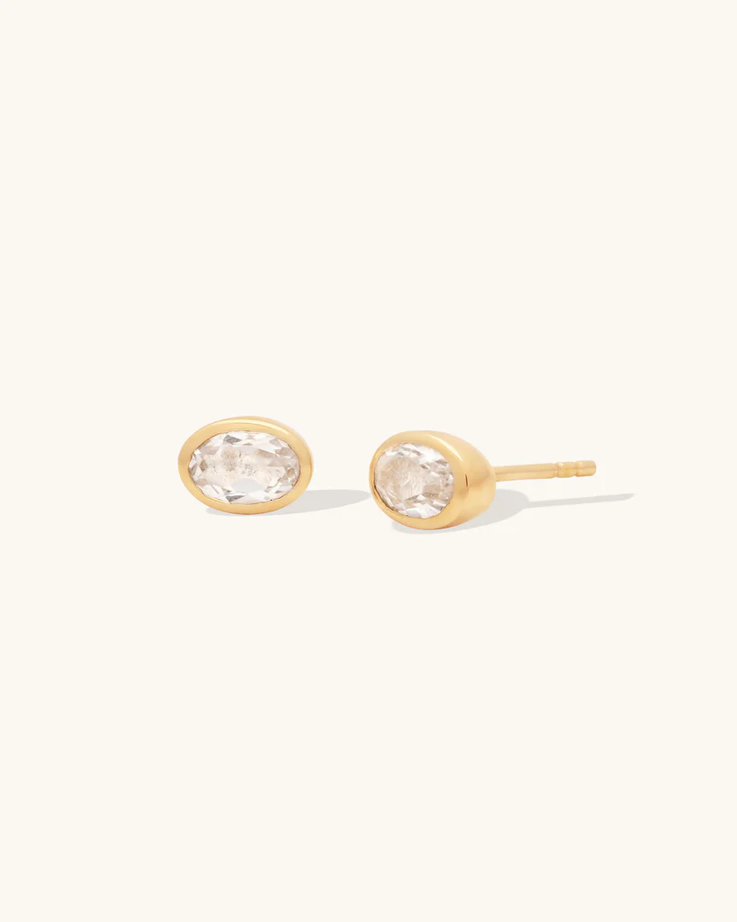 14k Yellow gold Plated sterling silver bezel studs, in an oval shape with a white topaz gemstone