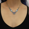 Plated Sterling Silver Bird Necklace predominantly featuring many strung together beads with the main colours being tones of blue and metal | on model