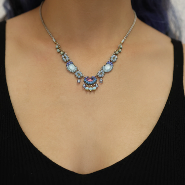 Plated Sterling Silver Bird Necklace predominantly featuring many strung together beads with the main colours being tones of blue and metal | on model