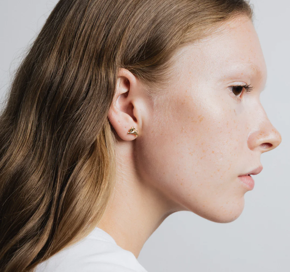Small bunny shaped stud earring made from 14k gold plated Brass | on model