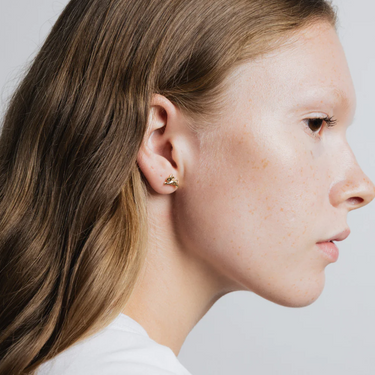 Small bunny shaped stud earring made from 14k gold plated Brass | on model
