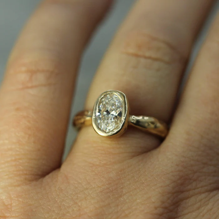 Bezel Set Solitare solid 14k yellow gold ring, featuring a 1.06ct  Oval lab-grown diamond | on model