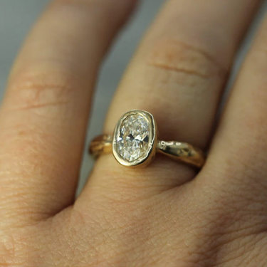 Bezel Set Solitare solid 14k yellow gold ring, featuring a 1.06ct  Oval lab-grown diamond | on model