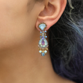 Silver Plated Bird Set Flamingo Earrings with a teardrop shaped base with beads hanging by gold  threads | on model