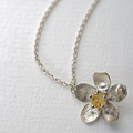 Silver Necklace with a Buttercup flower and Citrine Gemstone at the middle