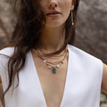 Seda Necklace featuring an asymmetrical assortment of gemstones and Freshwater Pearls in unique colours and textures combined with layers of reclaimed brass chains and gold-plated brass details.  | on model