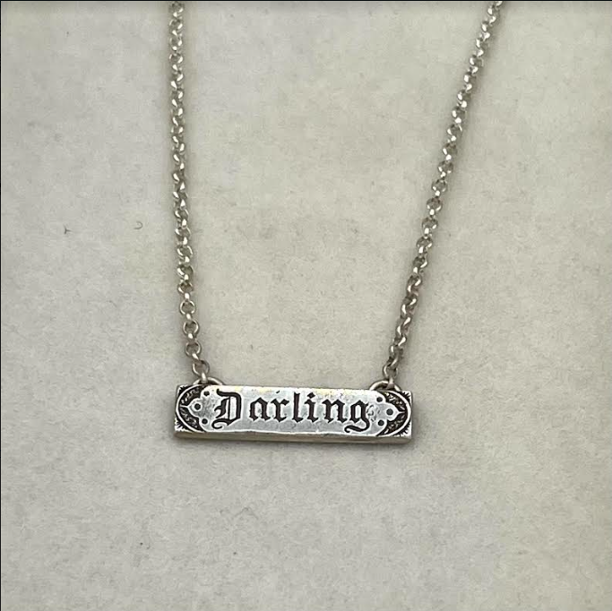 Darling, a dearly loved person. Beautiful stationary pendant on a sterling silver rolo style chain.