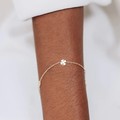 14k Yellow Gold Bracelet with a 4 leaf Clover, Dew Drop, and Eye Shaped Charms  | On Model