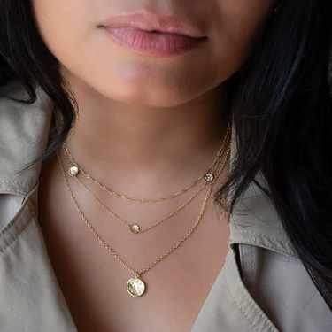 18k Yellow Gold Hammered Disc Necklace with a 10mm DIamond Spray Pendant, and 10 diamonds studded within. | on model