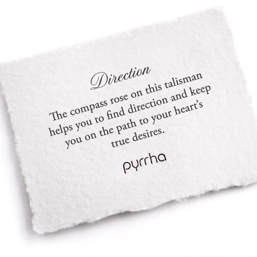 A Pyrrha Note describing the direction talisman. It reads, " the compass rose on this talisman helps you to find direction and keep you on the path to your hearts true desires."