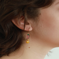 Short gold earrings with colorful beads in varied shapes and a pewter nugget | on model