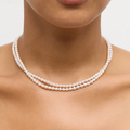 14k Yellow gold necklace featuring two strands of petite oval pearls, connected by a toggle clasp ( white pearls depicted in picture) | on model