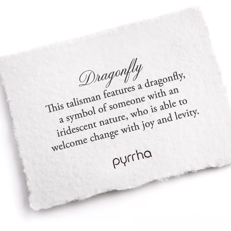 A Pyrrha note describing the Dragonfly talisman. It reads, "This talisman features a dragonfly, a symbol of someone with an iridescent nature, who is able to welcome change with joy and levity."