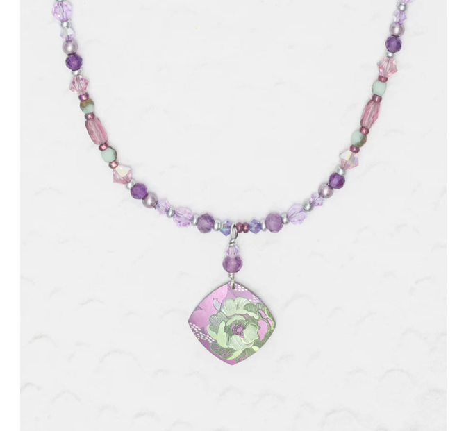 Niobium Beaded Necklace with purple and white beads featuring a purple pendant in the shape of a diamond with a green floral design