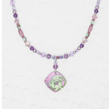 Niobium Beaded Necklace with purple and white beads featuring a purple pendant in the shape of a diamond with a green floral design