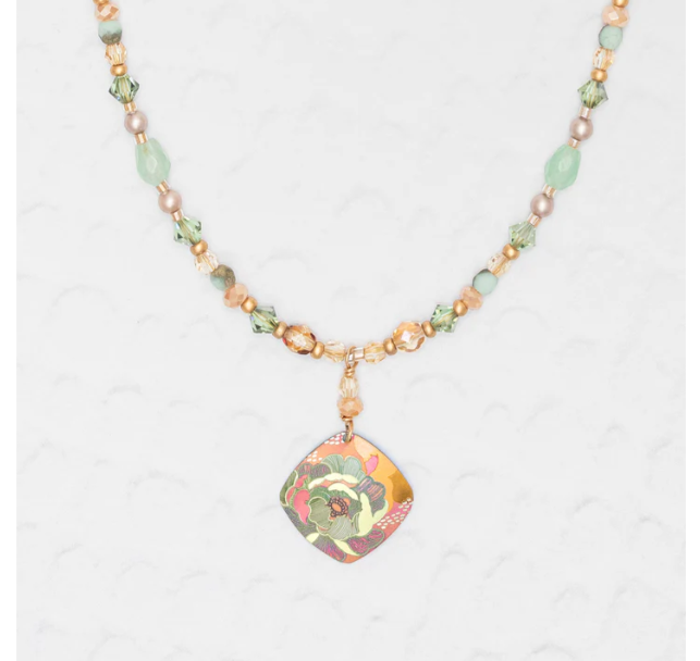 Niobium Beaded Necklace with orange and green beads featuring a diamond pendant with a green shaded flower and a warm toned design featuring pink and orange