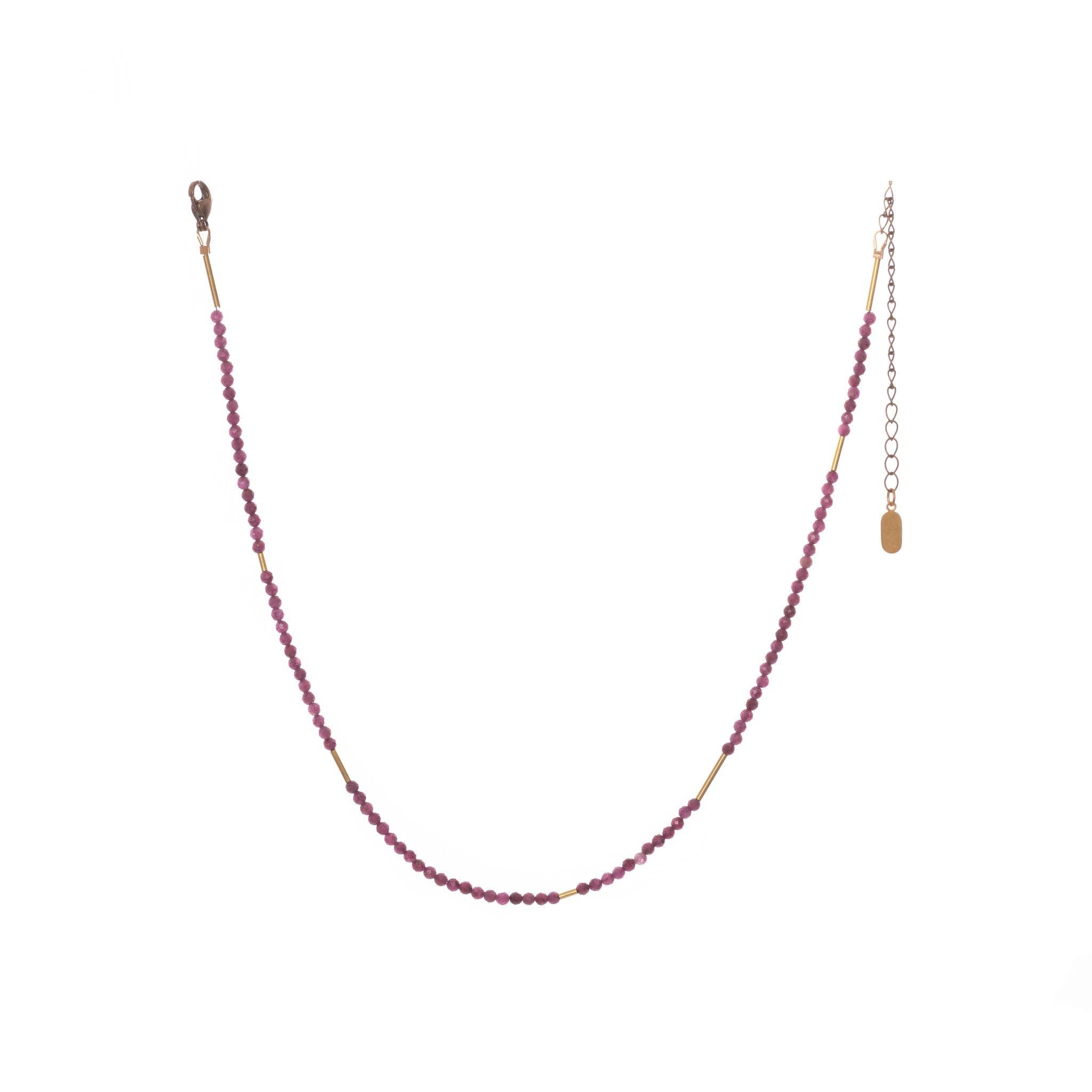 The Oso Necklace features hand-cut gemstones and recycled brass bars of varied lengths