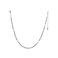 The Oso Necklace features hand-cut gemstones and recycled brass bars of varied lengths