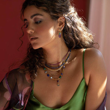 The Oso Necklace features hand-cut gemstones and recycled brass bars of varied lengths | on model