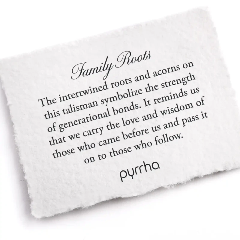 A Pyrrha note describing the Family roots talisman. It reads, "The intertwined roots and acorns on this talisman symbolize the strength of generational bonds. It reminds us that we carry the love and wisdom of those who came before us and pass it on to those who follow."