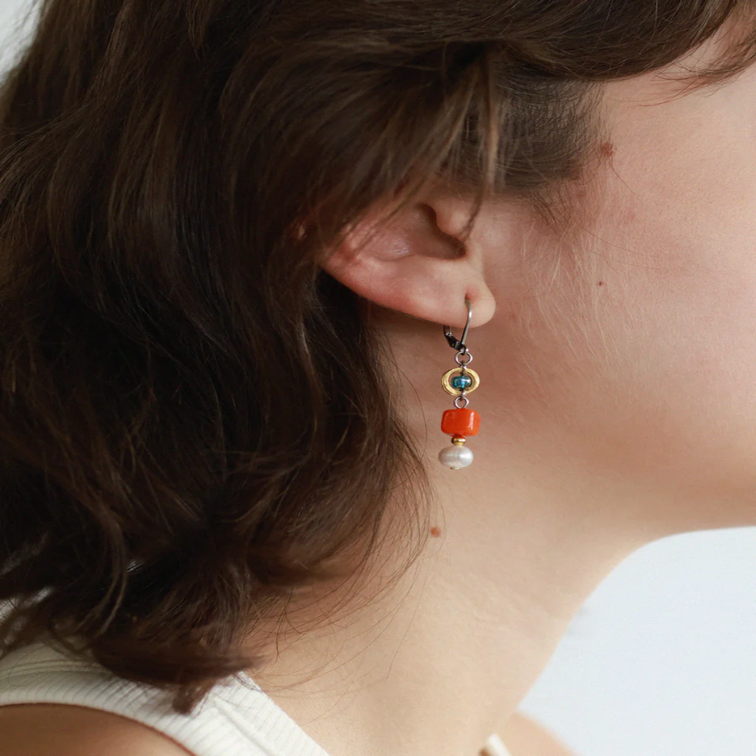 Short Two Toned earrings featuring pewter accents, colorful glass beads, and a freshwater pearl | on model