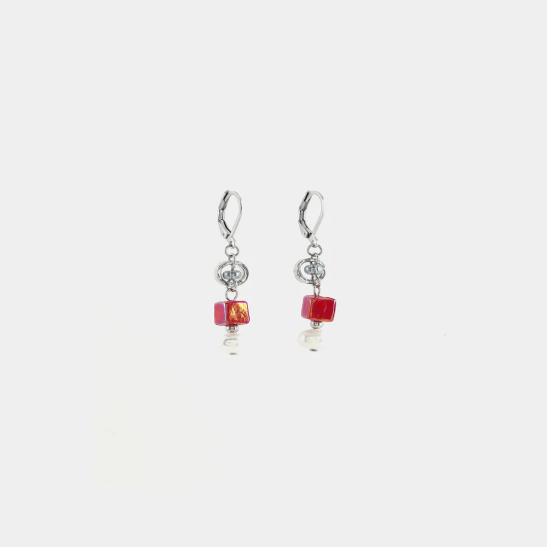 Short silver earrings featuring pewter accents, colorful red glass beads, and a freshwater pearl