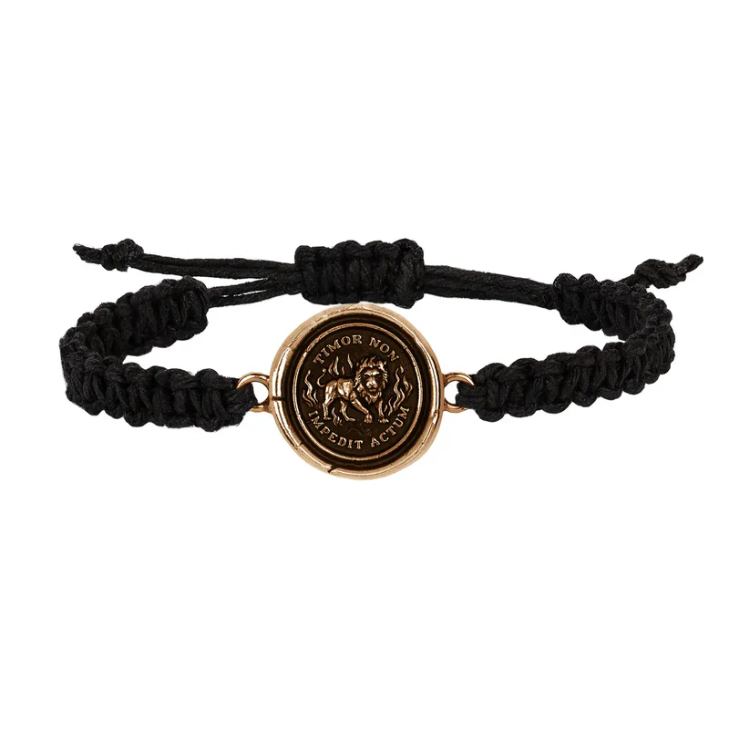 Black braided Bracelet with a Bronze talisman depicting a lion surrounded by flames and including the words "Timor Non Impedit Actum"