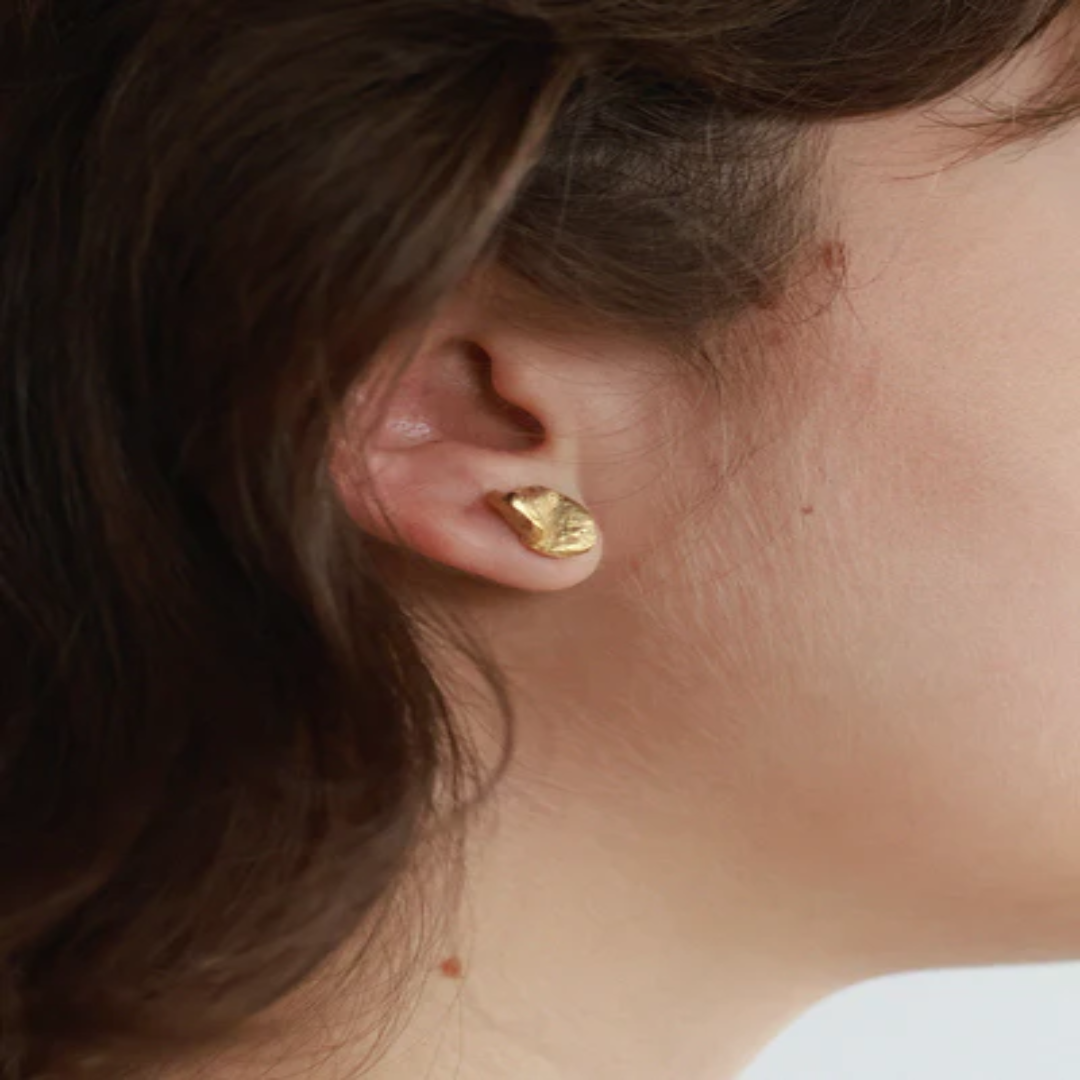Matte Gold pewter stud earrings sculpted into a petal shape | on model