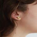 Matte Gold pewter stud earrings sculpted into a petal shape | on model