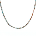 necklace featuring a striking combination of brass-edged Turquoise, Hessonite, and Moonstone beads, with a brass toggle clasp and a 14K gold-plated brass spike charm.