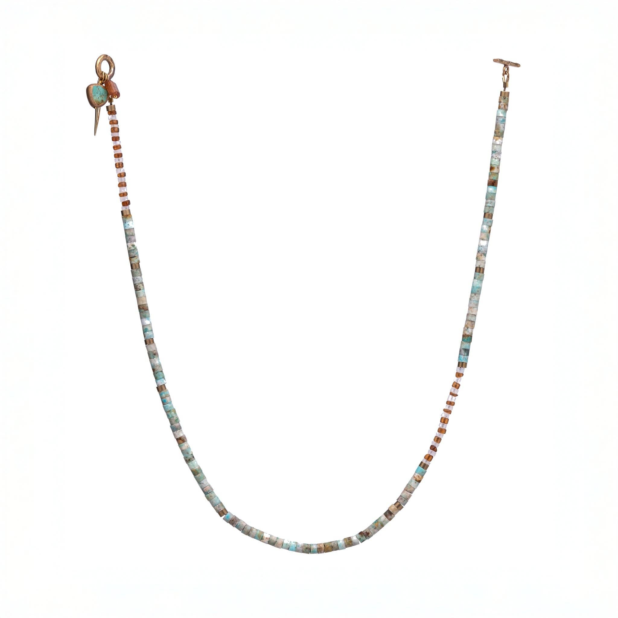 necklace featuring a striking combination of brass-edged Turquoise, Hessonite, and Moonstone beads, with a brass toggle clasp and a 14K gold-plated brass spike charm.