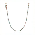 necklace featuring a striking combination of brass-edged Turquoise, Hessonite, and Moonstone beads, with a brass toggle clasp and a 14K gold-plated brass spike charm.